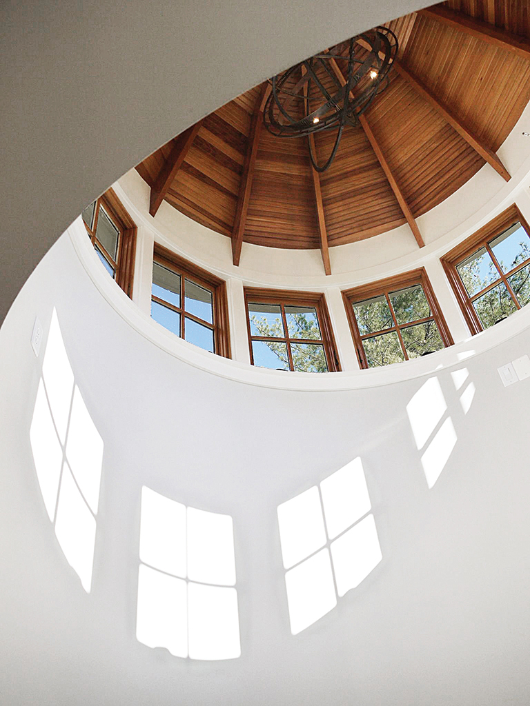 Clerestory windows catch the light in a curved stair tower with timbered ceiling. ARCHITECTURE: Rill Architects PHOTOGRAPHY: Rill Architects