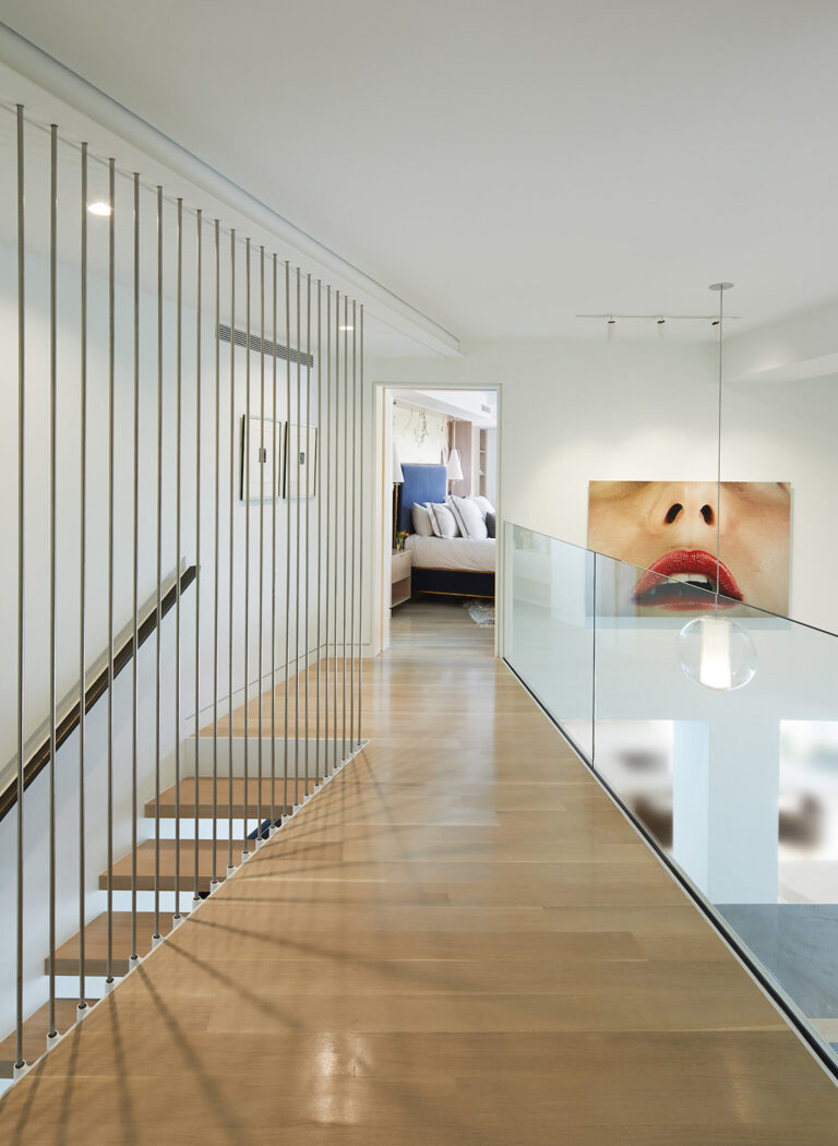 The primary suite is accessed from a bridge that spans a double-height living space.ARCHITECTURE: EL STUDIO PHOTOGRAPHY: Anice Hoachlander/Studio HDP