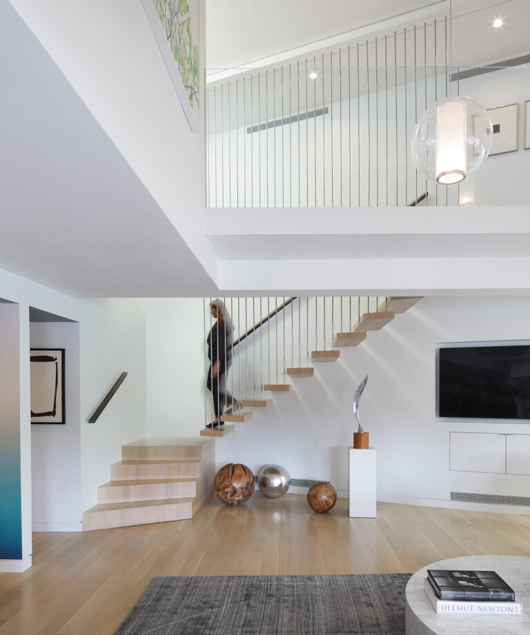 The polygonal shape of this apartment is resolved by the communicating stair, which is a series of cantilevered parallelogram white oak treads. ARCHITECTURE: EL STUDIO PHOTOGRAPHY: Anice Hoachlander/Studio HDP