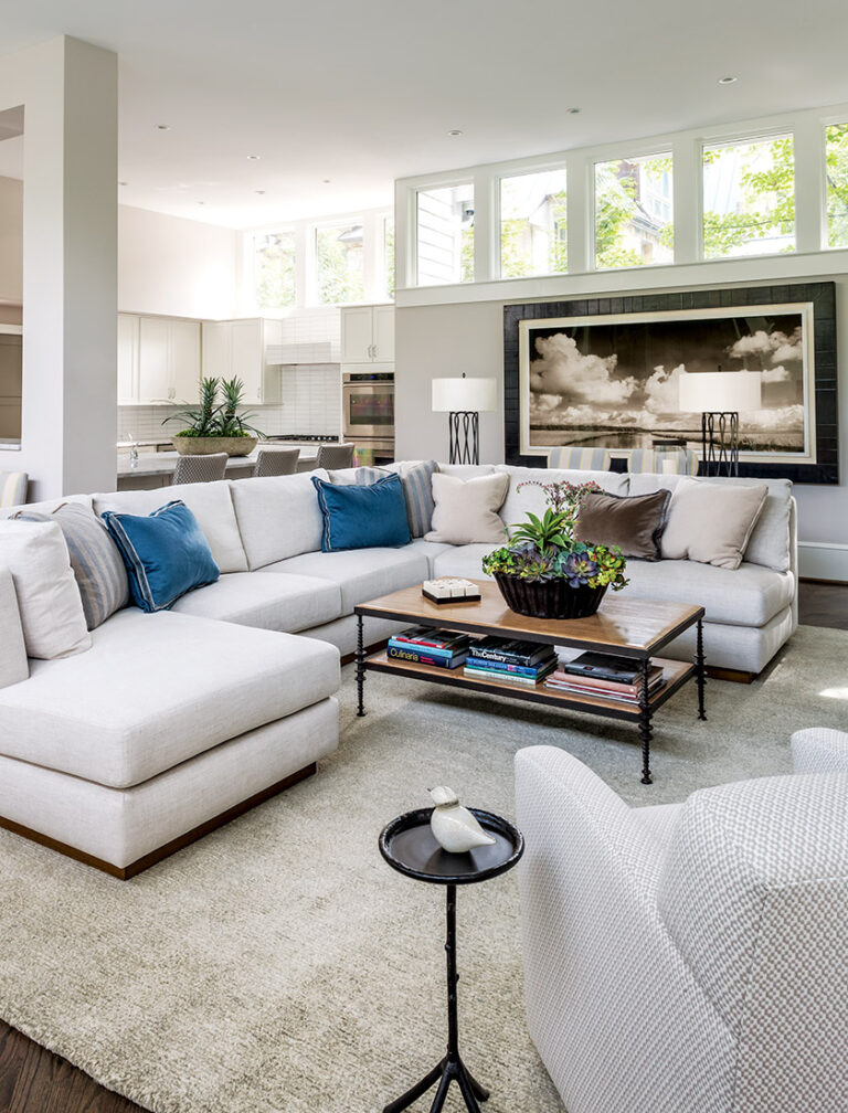 An A. Rudin sectional offers ample seating in the great room; a landscape photograph by Ben Ham presides over the space. INTERIOR DESIGN: Monarch Design DC PHOTOGRAPHY: Lydia Cutter