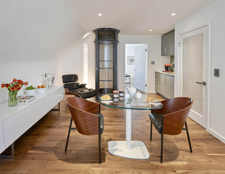 In-law suite complete with elevator, bedroom, sitting room, bathroom, kitchenette, and coffee bar—each just steps apart and beautifully appointed. ARCHITECTURE: CARNEMARK design + build PHOTOGRAPHY: Anice Hoachlander