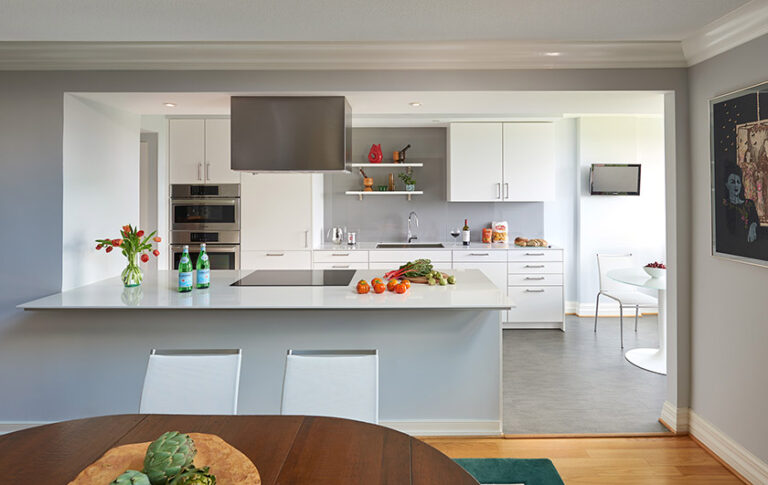The owners of this Northwest DC condo wanted more elbow room in their narrow galley kitchen. A space-conscious remodel came with bringing down a wall—and the dreaded popcorn ceiling—to open up the kitchen to the adjacent double-height dining and living space. ARCHITECTURE: CARNEMARK design + build PHOTOGRAPHY: Anice Hoachlander