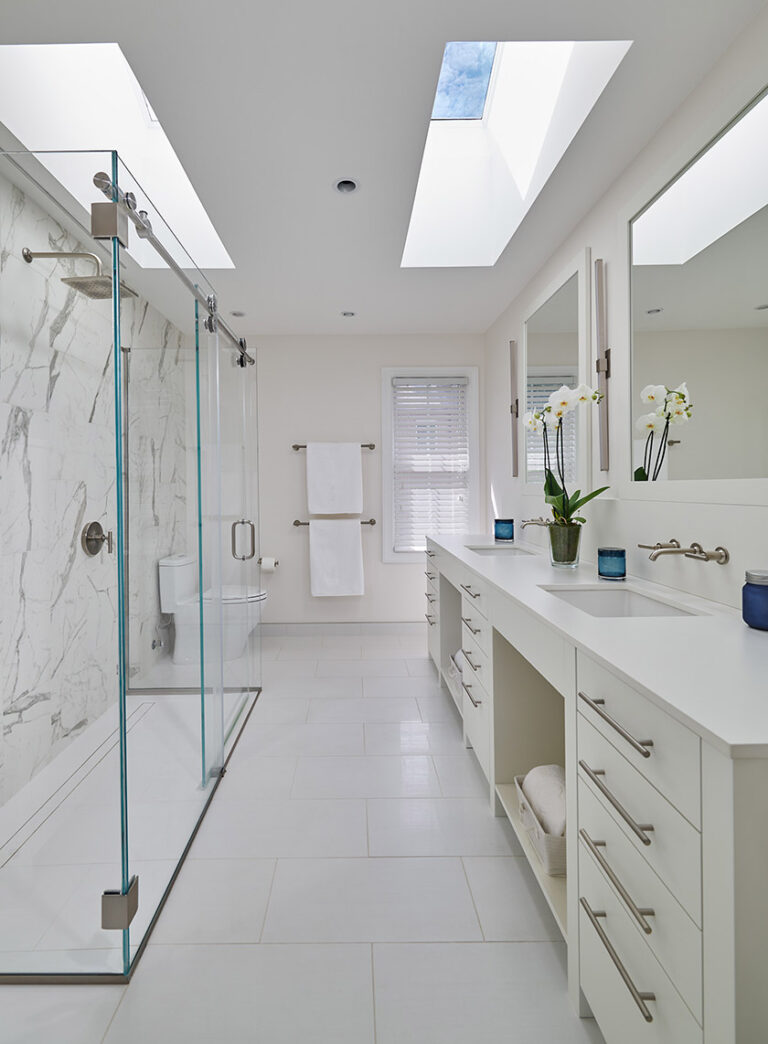 A double vanity with three drawer stacks and two open cubbies provides abundant storage for linens, toiletries, and more in this luxurious DC bathroom remodel. ARCHITECTURE: CARNEMARK design + build PHOTOGRAPHY: Anice Hoachlander