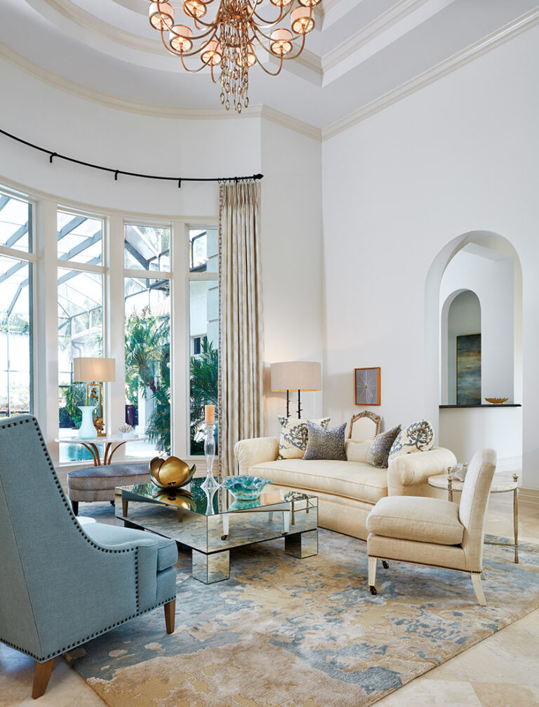 The two-story living room conveys drama via brilliant hues inspired by the Florida waters. INTERIOR DESIGN: Interior Concepts, Inc. PHOTOGRAPHY: Brantley Photography