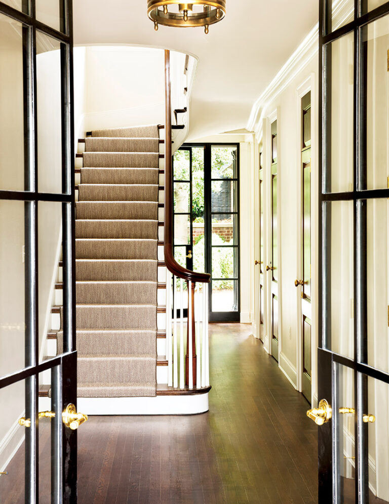 The historic home’s integrity is maintained in the rebuilt stairway and new steel-framed doors that open to the backyard. ARCHITECTURE: Donald Lococo Architects, LLC PHOTOGRAPHY: JOHN COLE