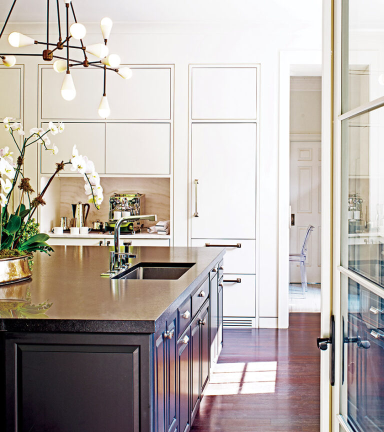 An award-winning kitchen marries modern, full-height, white cabinets with an island clad in raised, black panels. ARCHITECTURE: Donald Lococo Architects, LLC PHOTOGRAPHY: John Cole