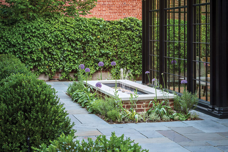 A focal point of a Kalorama garden is the fountain, planted at its base with evergreen herbs like lamb’s ear and rosemary for year-round interest. LANDSCAPE ARCHITECTURE: Horn & Co. PHOTOGRAPHY: Allen Russ