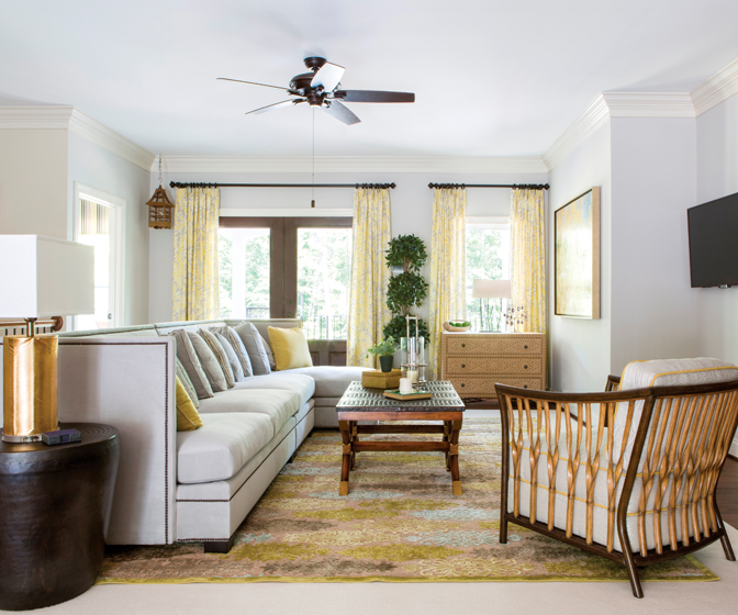 Layered rugs create warmth while defining a floating seating group that features a faux crocodile table and a woven-frame lounge chair. INTERIOR DESIGN: Lorna Gross Interior Design PHOTOGRAPHY: Angie Seckinger