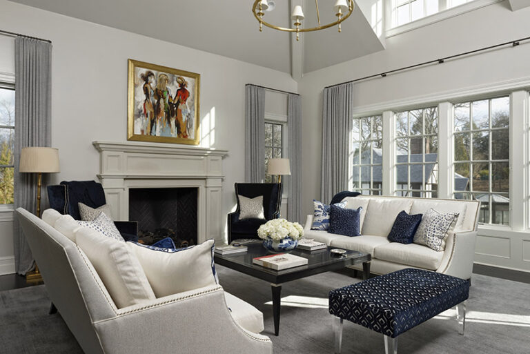 Farrow & Ball paint sets the tone for this blue and white family room. Custom artwork takes center stage over the mantel. Sofas by Lee Industries are used to anchor the room. INTERIOR DESIGN: MAX Interiors PHOTOGRAPHY: Bob Narod