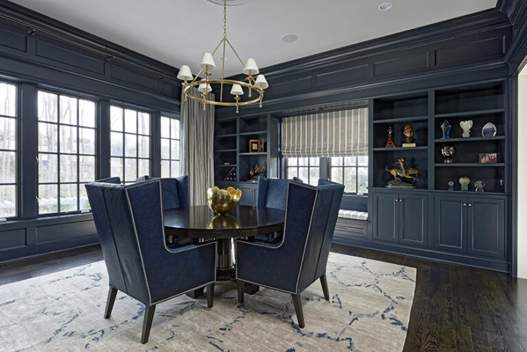 Custom built-ins by Artisan Builders painted in Farrow & Ball Hague Blue anchor this library. Custom area rug by Carpet Creations Leather chairs by Lee Industries create an intimate meeting space. INTERIOR DESIGN: MAX Interiors PHOTOGRAPHY: Bob Narod