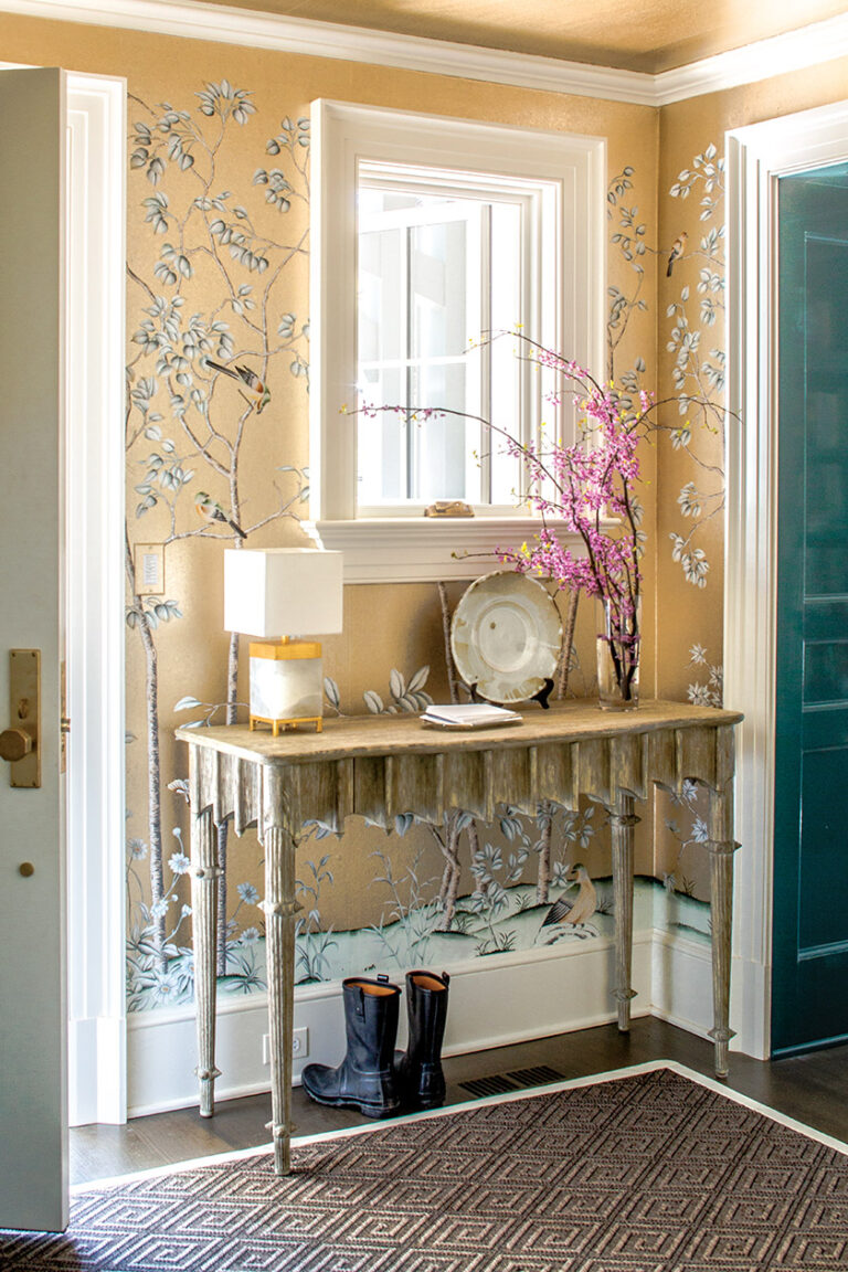 A whimsical console with drawers for keys and leashes is set against a glamorous background of painted wallpaper. INTERIOR DESIGN: Sroka Design Incorporated PHOTOGRAPHY: ERIK KVALSVIK