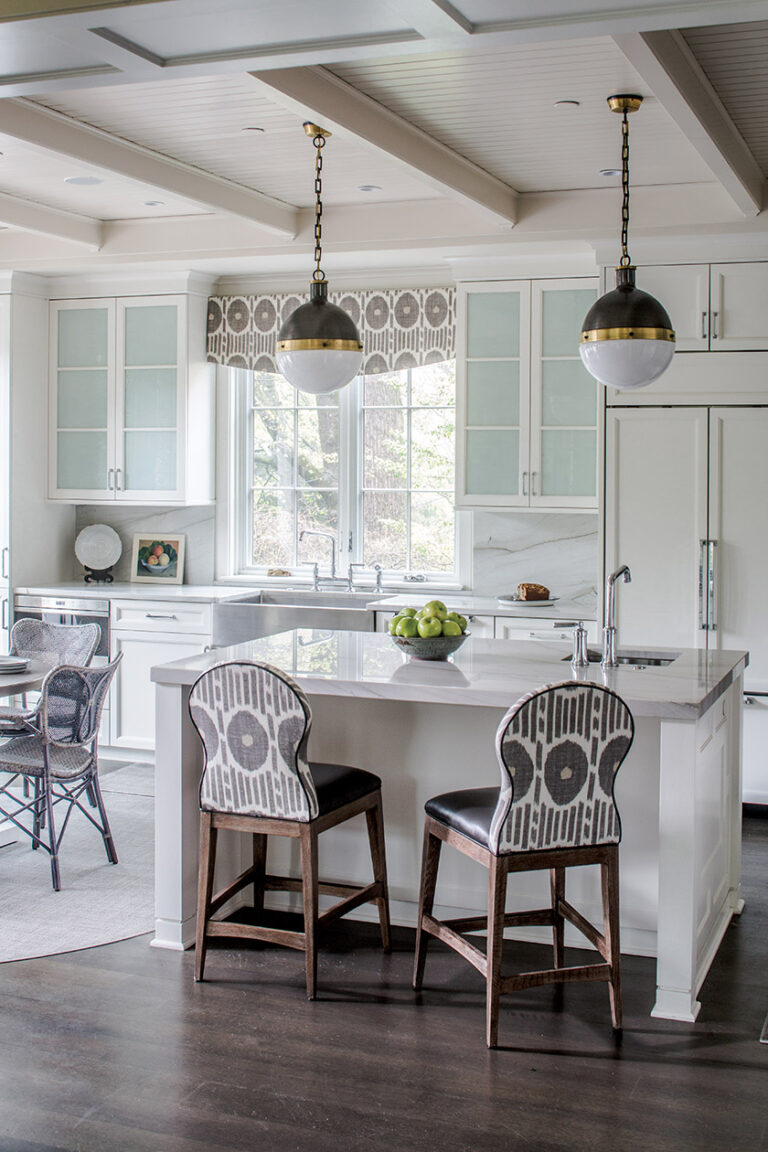 Frosted-glass cabinet doors strike a sophisticated note in an inviting kitchen. INTERIOR DESIGN: Sroka Design Incorporated PHOTOGRAPHY: ERIK KVALSVIK