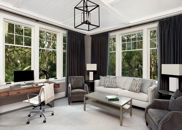 An inviting family room in grays and blues doubles as an out-of-town office in a coastal home. INTERIOR DESIGN: Sroka Design Incorporated PHOTOGRAPHY: Holger Obenaus