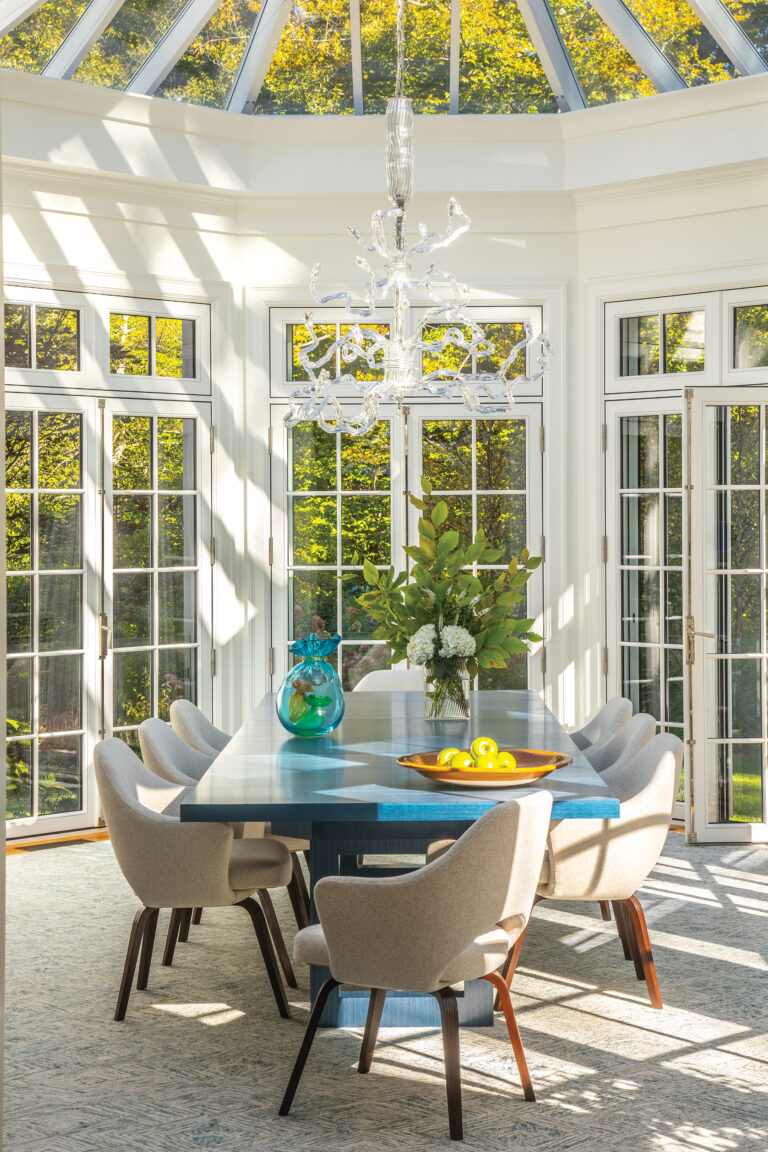 Lit by a series of French doors and a glass ceiling, a solarium addition designed by BarnesVanze Architects houses the dining room. The custom table is by Keith Fritz.