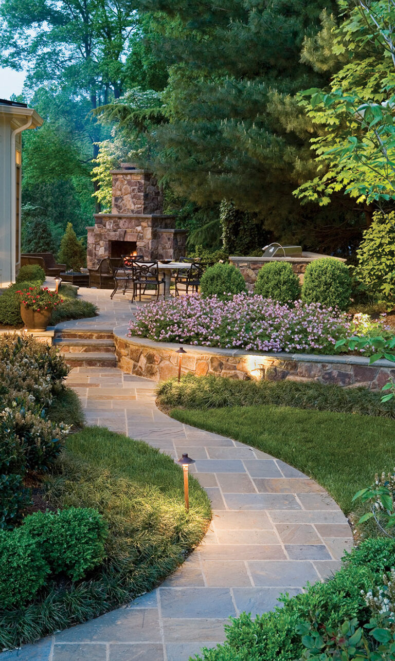 A narrow backyard maximizes its space with stone walls, a fireplace, a grill and a bar. LANDSCAPE ARCHITECTURE: Surrounds Landscape Architecture + Construction PHOTOGRAPHY: Bob Narod
