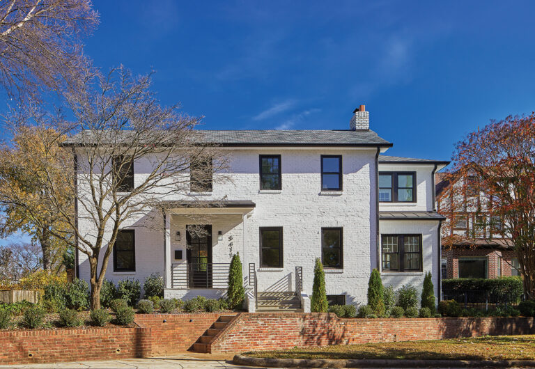 Crisp, white paint and a new roof dramatically refresh an existing brick exterior; updated windows with black exterior frames play up curb appeal. ARCHITECTURE: CARNEMARK / KONST PHOTOGRAPHY: Anice Hochlander