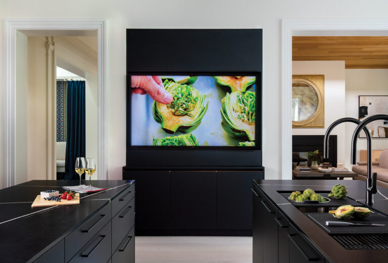 A 75-inch LED screen provides access to a favorite recipe or family video call—all from the prep island. ARCHITECTURE: CARNEMRK design. + build PHOTOGRAPHY: Ron Blunt