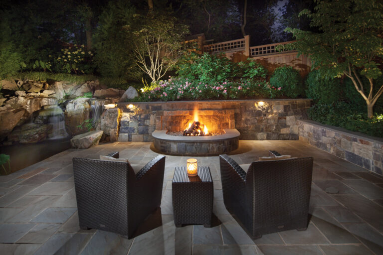 Surrounds turned a steep slope in a small yard into a cozy sitting area by building a retaining wall with a fire pit and waterfalls to the left. LANDSCAPE ARCHITECTURE: Surrounds Landscape Architecture + Construction PHOTOGRAPHY: Morgan Howarth