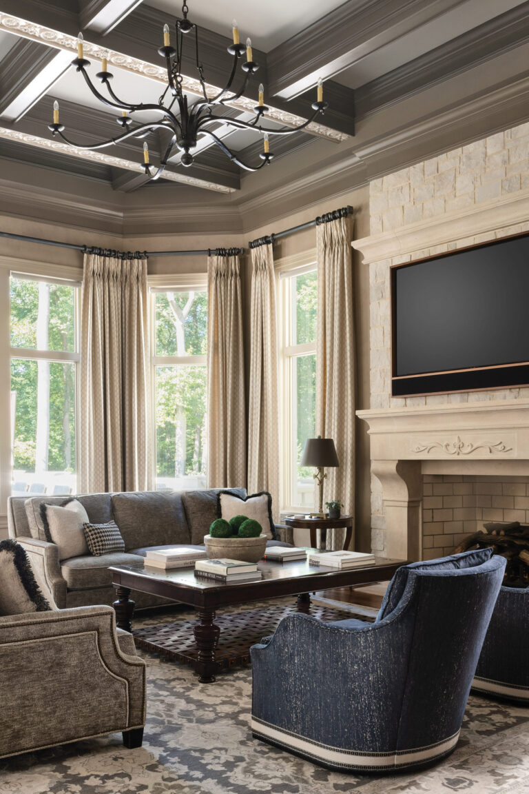 Day-to-day living occurs in the great room—the centerpiece of the residence—where lush fabrics, a stone fireplace and a coffered ceiling embellished with hand-painted plaster accents envelop residents and guests in a warm embrace. INTERIOR DESIGN: Interior Concepts, Inc. PHOTOGRAPHY: Stylish Productions