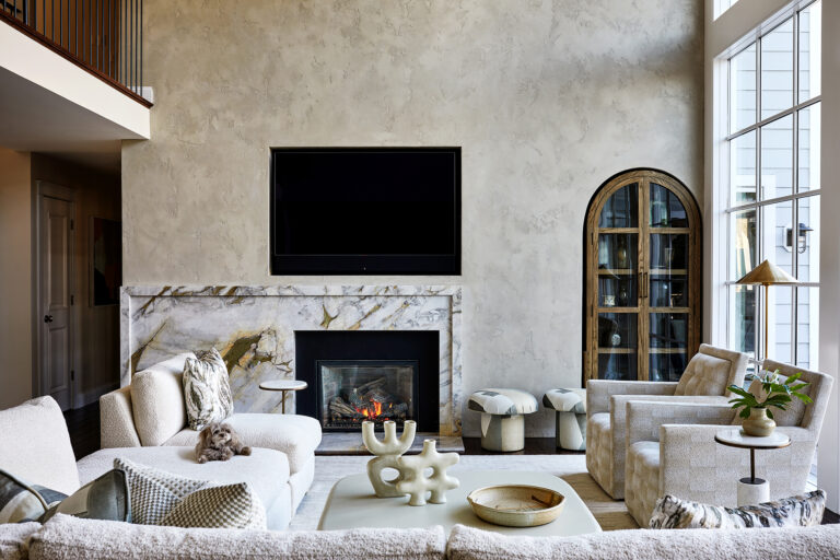 At the heart of the home, this living room creates a elevated place to entertain and captures the stunning waterfront view. ARCHITECTURE: The Drawing Board, Inc. PHOTOGRAPHY: Stacey Goldberg