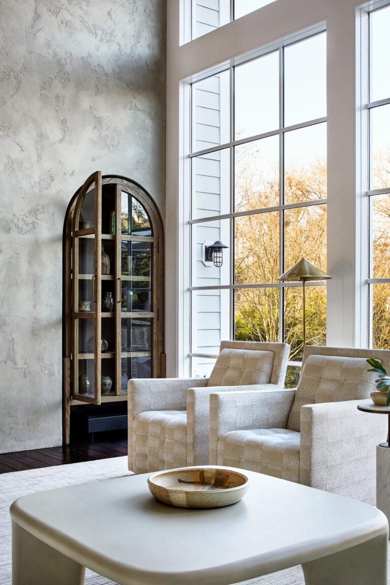 Two-story, floor-to-ceiling windows fill the living room with light and frame the view of the water.ARCHITECTURE: The Drawing Board, Inc. PHOTOGRAPHY: Stacey Goldberg
