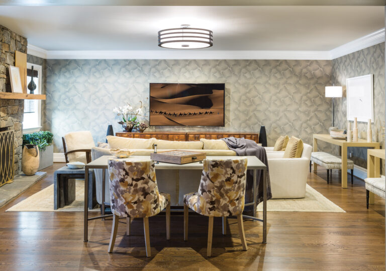 Intended for a family with older kids, a “grown-up” basement room in McLean is warmed by textured wallpaper, a velvet sofa and swivel chairs. INTERIOR DESIGN: Samantha Friedman Interior Designs, LLC PHOTOGRAPHY: Jesse Snyder