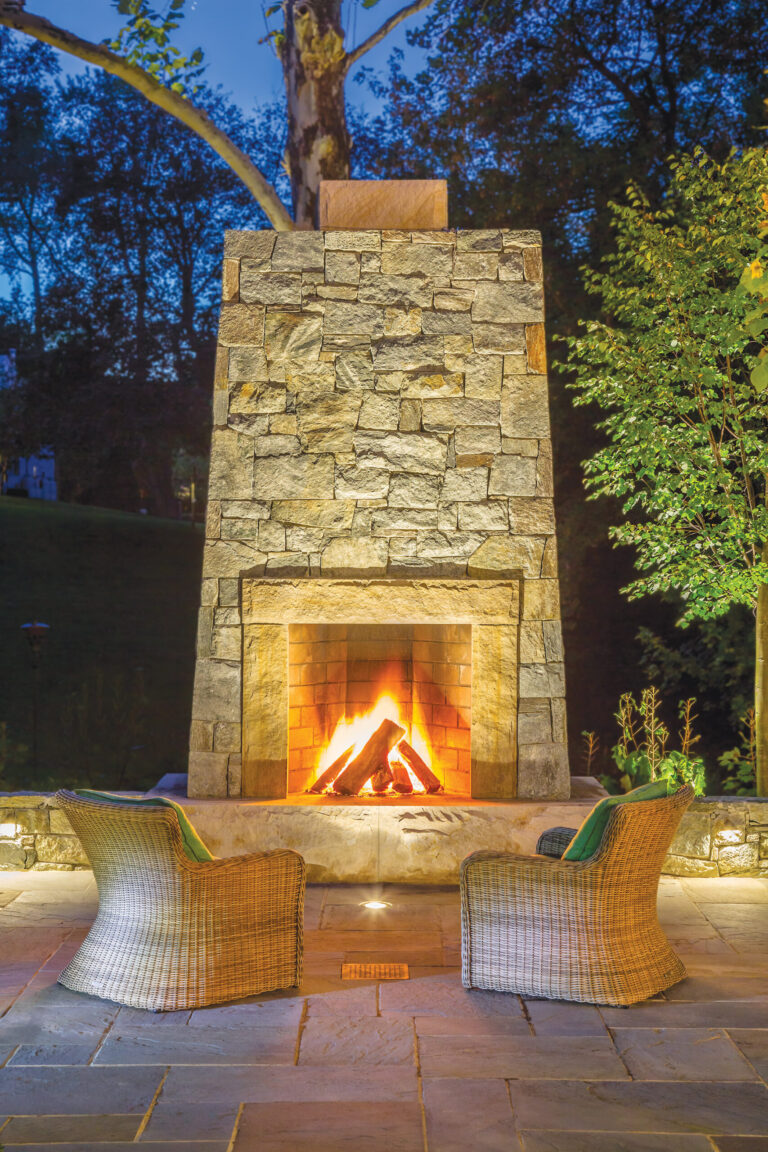 A stone fireplace creates a focal point on a terrace; designed to accommodate generous fires, it connects the eye to nature and makes for enjoyable evenings in the garden. LANDSCAPE DESIGN: Katia Goffin Gardens PHOTOGRAPHY: Roger Foley