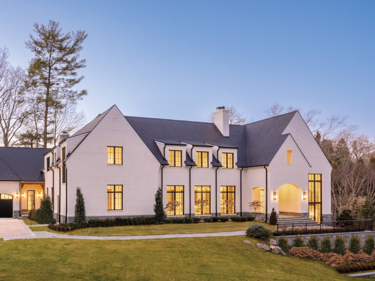 With simple, clean lines and traditional gable forms, a transitional English-style home graces its hillside setting. ARCHITECTURE: Harrison Design PHOTOGRAPHY: Sean Shanahan