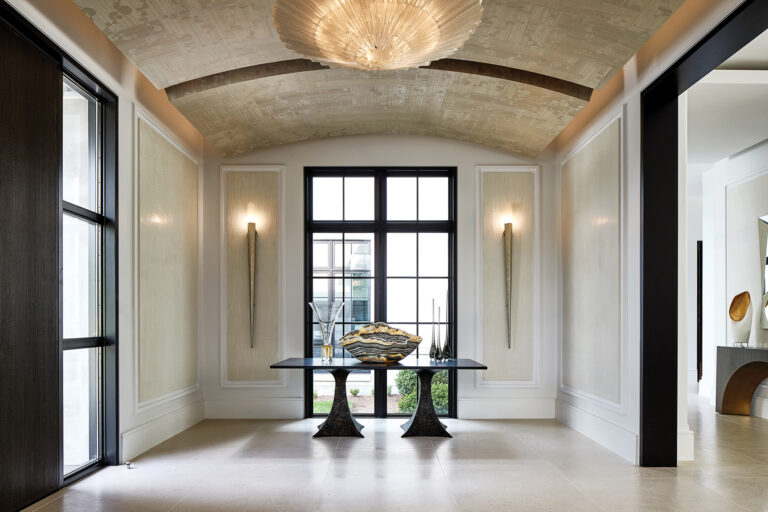 Intricate faux finishes and black trim lend timeless elegance to a foyer where the ceiling is clad in wood veneer decorated with a pattern of ginkgo leaves. INTERIOR DESIGN: Interior Concepts, Inc. PHOTOGRAPHY: Stacy Zarin Goldberg