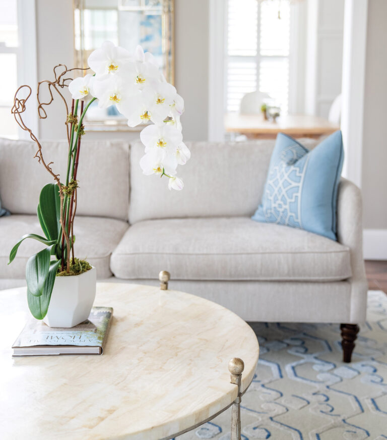 A round marble coffee table accents the light-blue-and-oyster geometric rug, creating interest in a sophisticated, fresh and comfy sitting area. INTERIOR DESIGN: Lorna Gross Interior Design PHOTOGRAPHY: Angie Seckinger