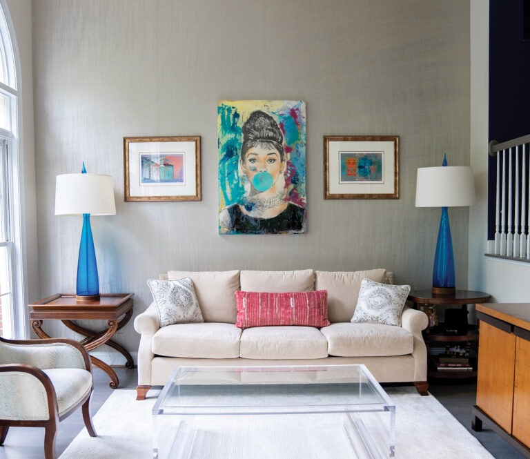 Unique art and neutral tones, complemented by pops of blue and magenta, transform a living room into a comfortable and classic haven. INTERIOR DESIGN: Lorna Gross Interior Design PHOTOGRAPHY: William Waldron