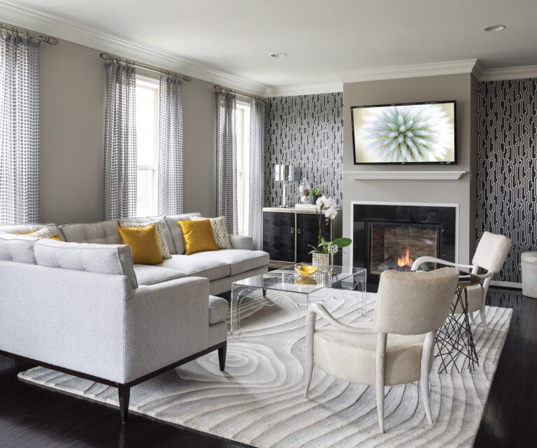 In a Maryland residence, a geometric metallic wall covering creates a backdrop for hair-on-hide chairs and a contemporary rug. INTERIOR DESIGN: Lorna Gross Interior Design PHOTOGRAPHY: Rachel Heacox
