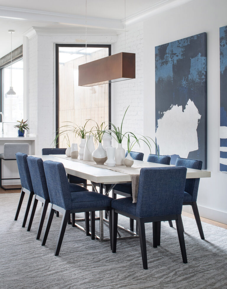 A Victorian row house was modernized with clean-lined furniture in the dining room and a mix of materials and finishes by the entry. INTERIOR DESIGN: Manlove and Company Interiors PHOTOGRAPHY: Stylish Productions