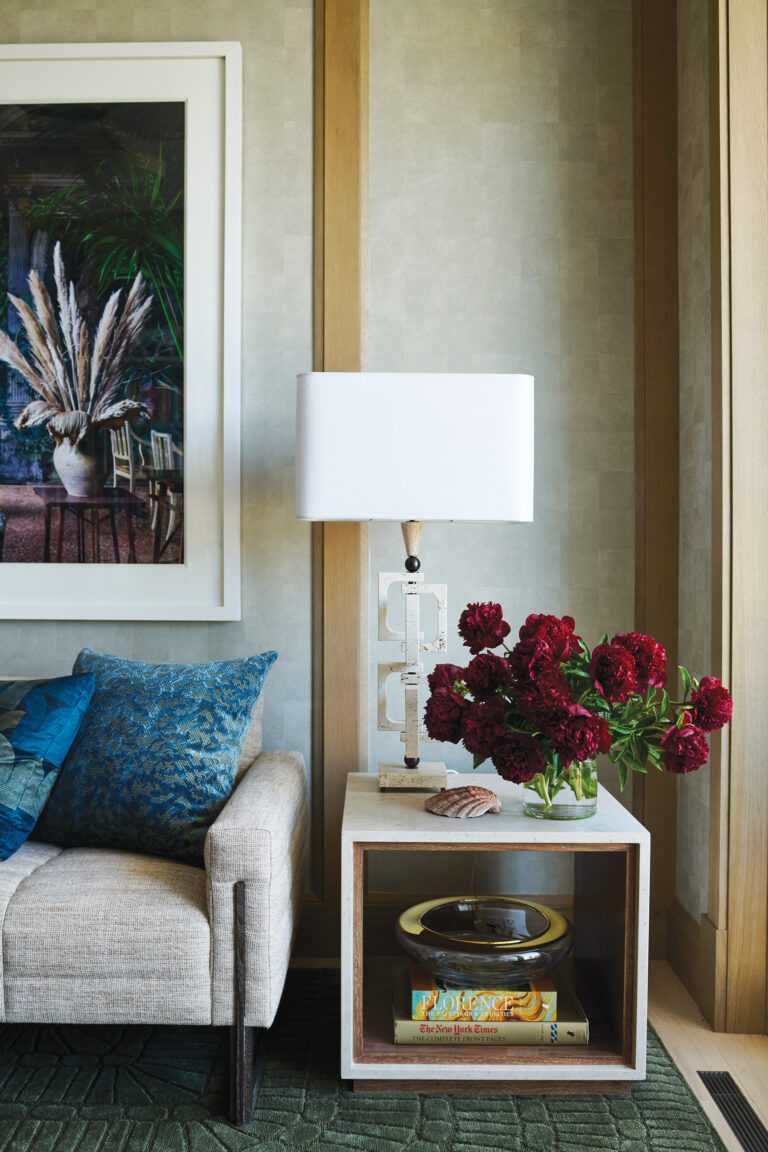 Artful furnishings in a Rehoboth Beach library include custom, travertine-wrapped end tables that match mid-century lamps sourced in Italy.