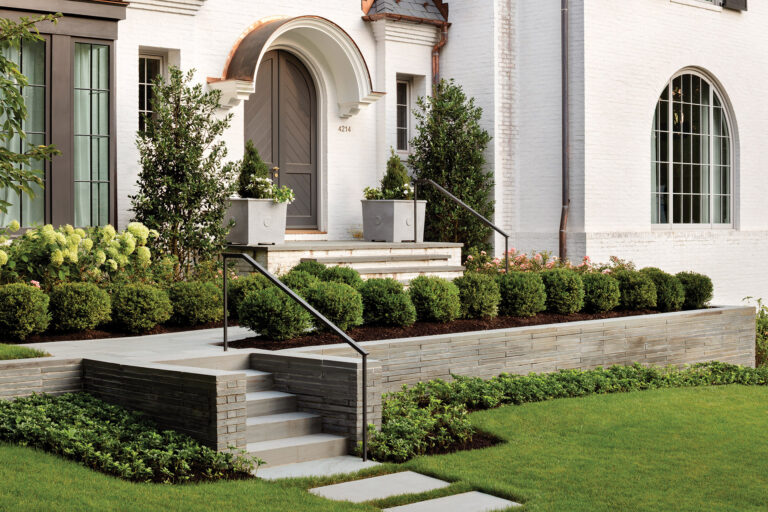 A formal front entry features landings that step up, softened by tidy beds of boxwood, oakleaf hydrangea, holly and rhododendron. LANDSCAPE ARCHITECTURE: Joseph Richardson Landscape Architecture PHOTOGRAPHY: Jennifer Hughes