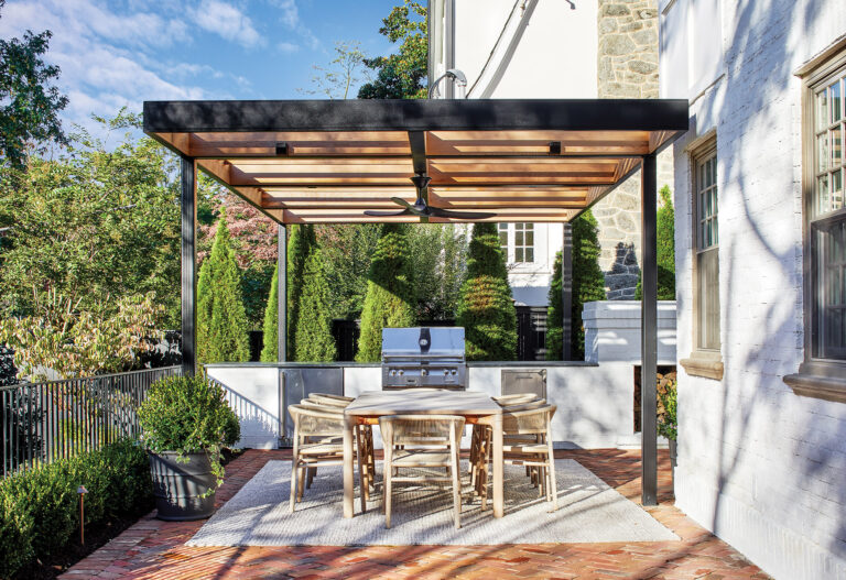 A sleek, steel pergola with cedar accents covers a brick dining terrace and outdoor kitchen. LANDSCAPE ARCHITECTURE: Joseph Richardson Landscape Architecture PHOTOGRAPHY: Stacy Zarin Goldberg