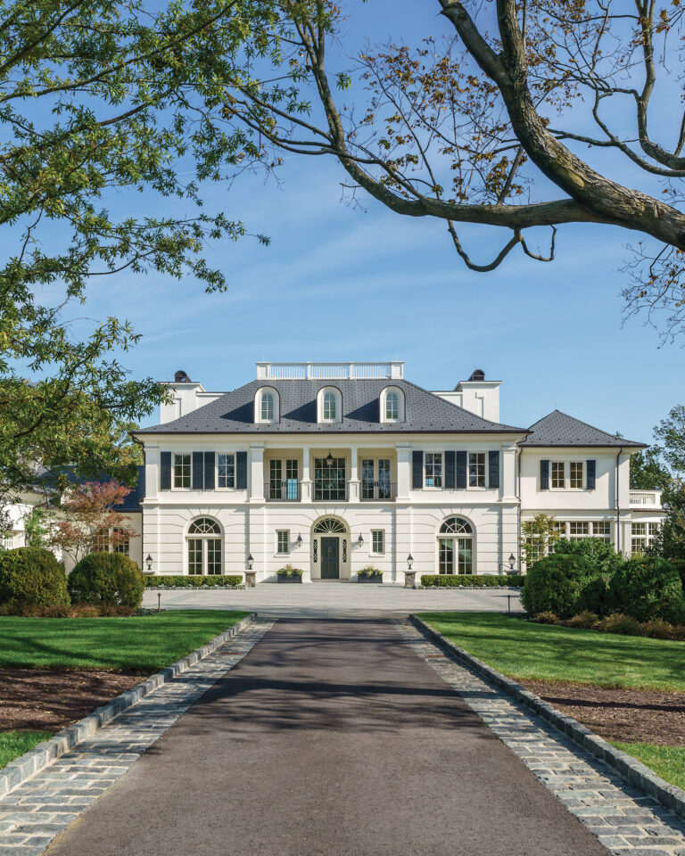 The front façade reveals a rusticated first floor, which lends scale to the front entry and motor court. ARCHITECTURE: Rill Architects PHOTOGRAPHY: Allen Russ