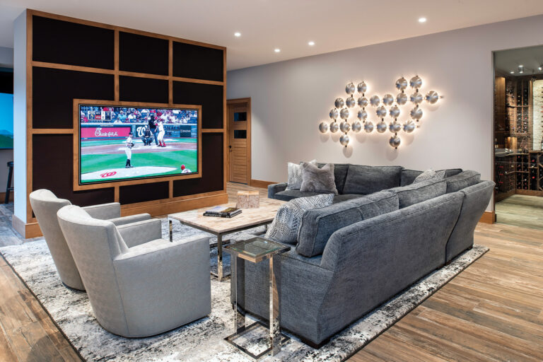 A space designed for entertainment showcases a 90-inch TV, a lighted wall sculpture INTERIOR DESIGN: Sandra Meyers Design Studio PHOTOGRAPHY: Maxine Schnitzer