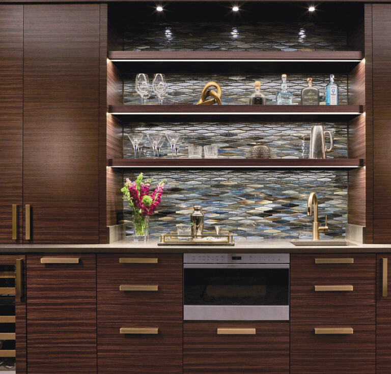 Custom cabinets, enhanced by an unusual glass backsplash tile, create a chic beverage bar in a Bethesda abode. INTERIOR DESIGN: Sroka Design, Inc. PHOTOGRAPHY: Geoffrey Hodgdon