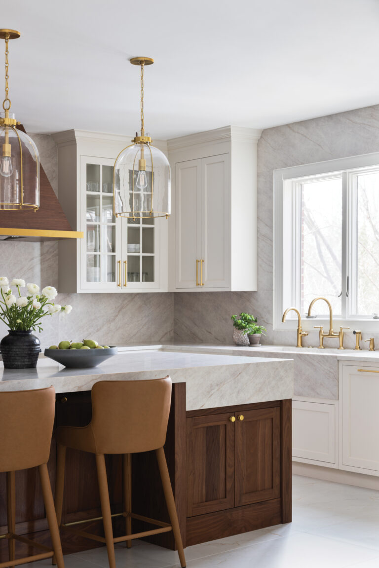 A furniture-style seating island in a Potomac kitchen combines a walnut base and thick, stone countertops.