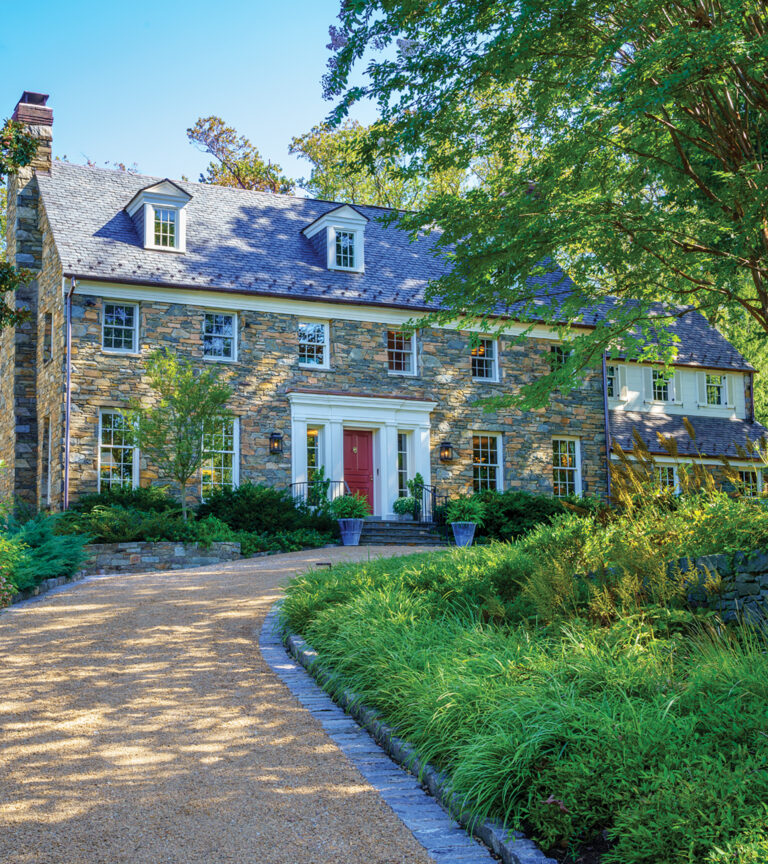 The carefully restored front façade received new gable-end dormers to punctuate the slate-roofed attic story.